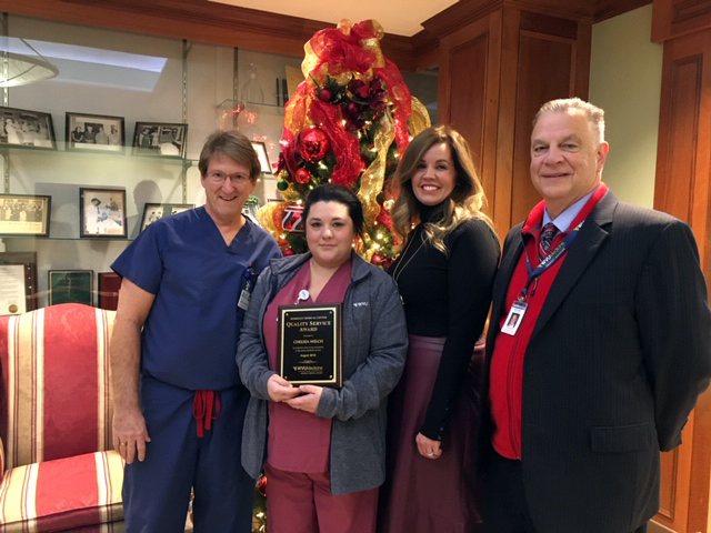 WVU Medicine Berkeley Medical Center’s August Quality Service Award winner is pictured receiving her award. Left to right: Director of Surgical Services Steve Folmer, QSA Winner Chelsea Welch, Vice President/Chief Nursing Officer Samantha Richards, and President/CEO Anthony P. Zelenka. 